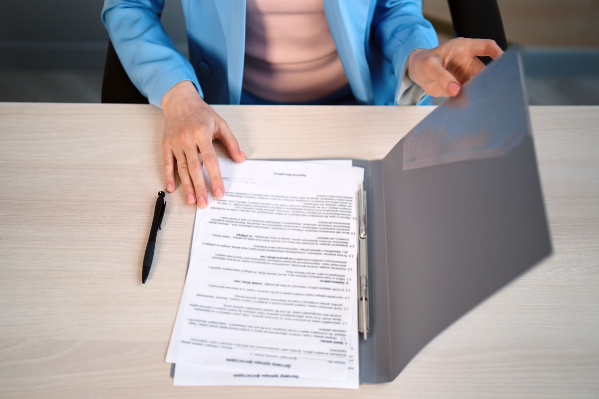 woman sitting at her desk and reading papers